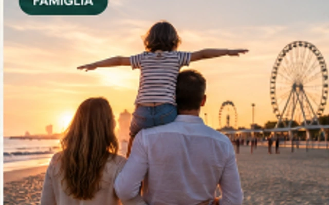 Famiglia con bambino sulla spiaggia di Rimini davanti alla Ruota Panoramica al tramonto